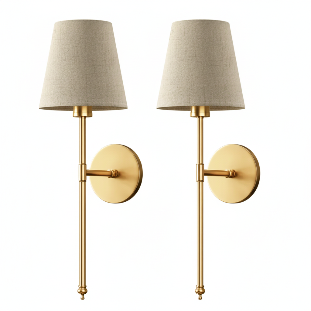 Two gold wall sconces with beige lampshades on a white background